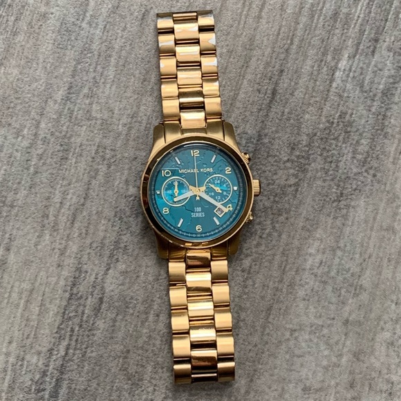 Michael Kors Accessories - Michael Kors ladies “feed the world” gold watch